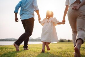 happy family in a park at sunset