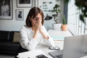 Tired Woman Freelancer Resting With Laptop At Table, Suffering F