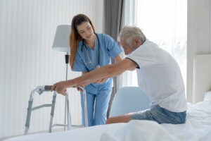 Elderly Man Talk To Doctors And Nurses In The Hospital. Senior